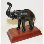 Vintage tooled leather over wood elephant mounted on a wooden plinth o/all height not including