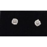 A pair of white gold diamond stud earrings 1/2 carat total weight.