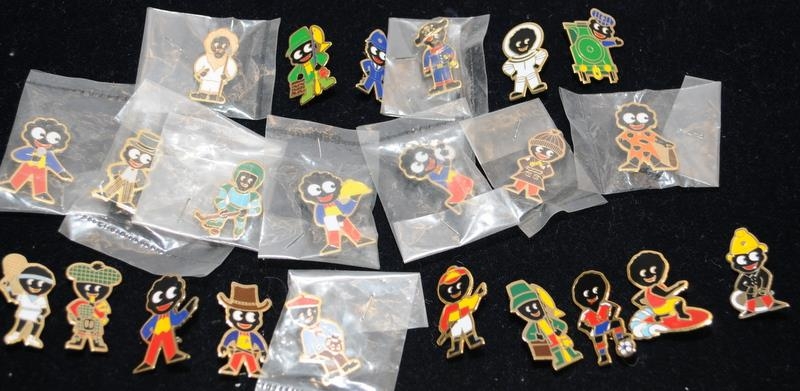 A collection of 23 Golly Badges.