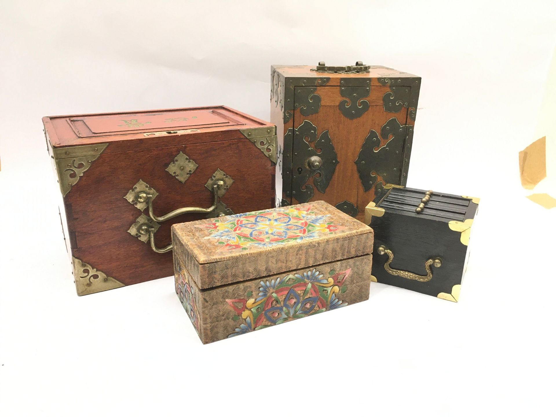 Four oriental style wooden boxes.