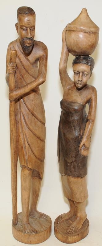 Pair of African carved wooden figures of a man and a woman standing 60cms tall