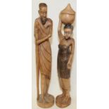 Pair of African carved wooden figures of a man and a woman standing 60cms tall