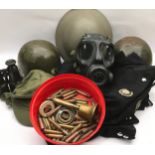 A box of helmets, militaria and bullet cases etc.