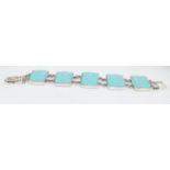 A silver and turquoise bracelet.