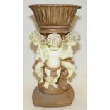 Large decorative resin plant stand featuring gilded bowl supported by Putti's. 48cms tall