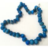 Ceramic bead necklace finished with Rimini Blue glaze. O/all length approx 75cm
