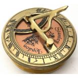 A brass cased compass and sundial