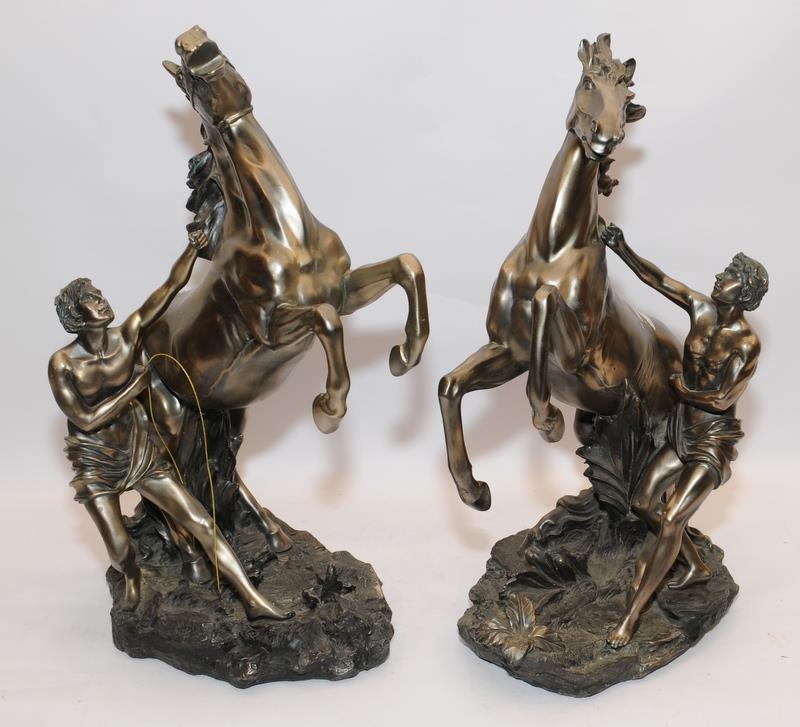 Handed pair of large bronzed resin classical horse and handler figures from the Academy