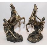 Handed pair of large bronzed resin classical horse and handler figures from the Academy