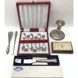 Collection of sterling silver items to include a candlestick, a set of six Wimbourne souvenir spoons
