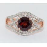 A mixed gold Garnet and Diamond ring.