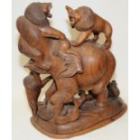 Very large wood carving depicting a bull elephant being attacked by five lions. 49cms tall