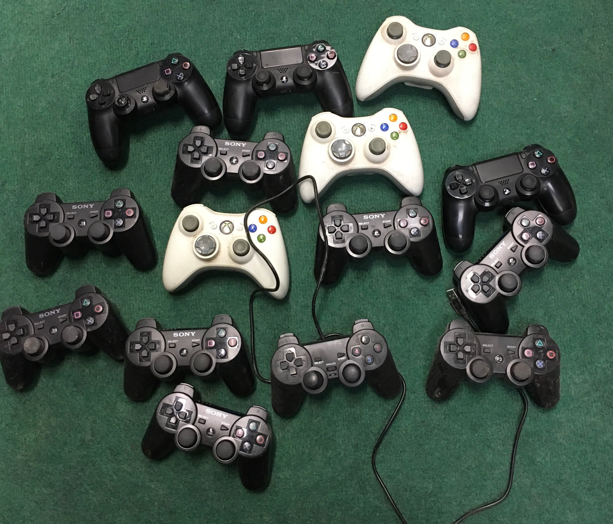 Collection of Xbox and PlayStation controllers. WP.