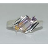 A silver ring with coloured gemstones , Size n