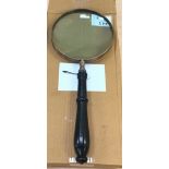 A large hand held magnifying glass.