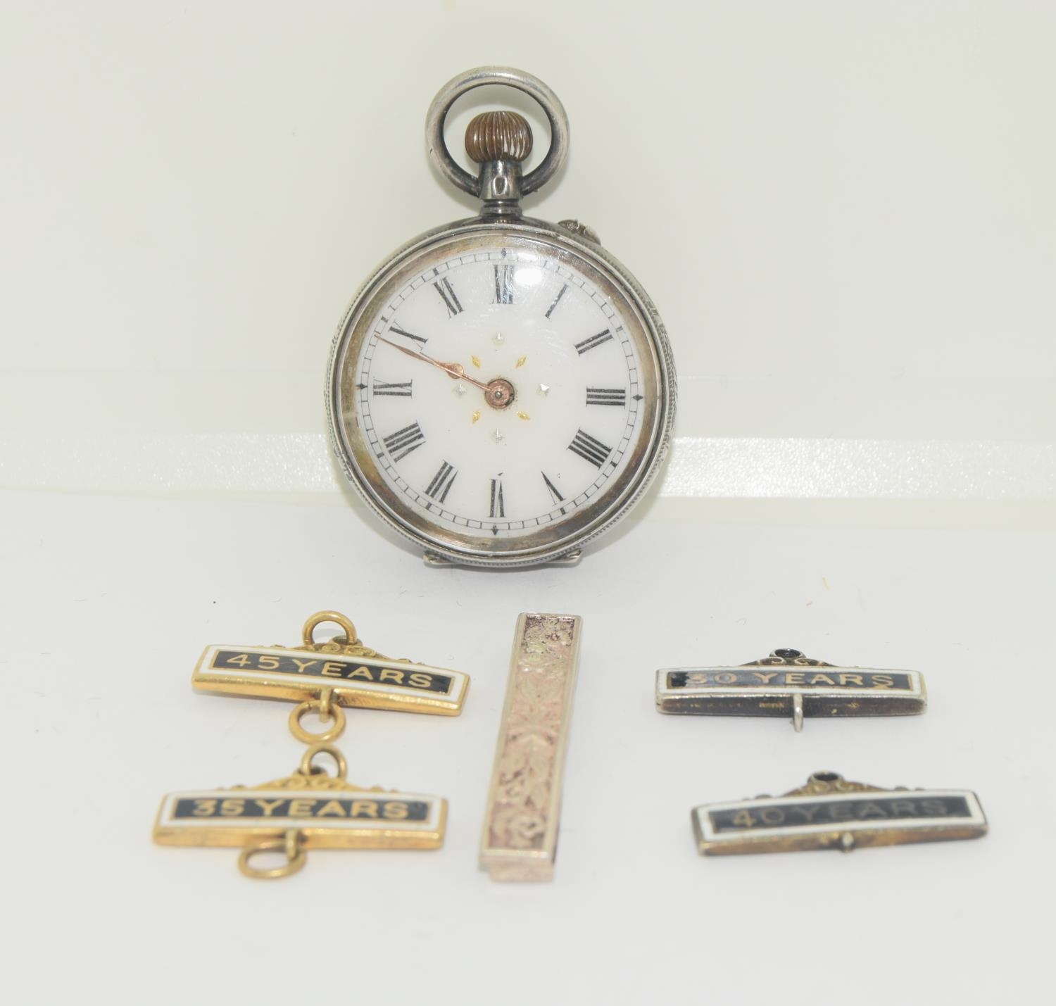 Silver pocket watch with silver St Johns Ambulance badges/service bars.
