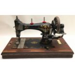 Vintage sewing machine in wooden case with key.