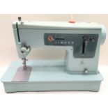 Vintage blue Singer sewing machine in original case.