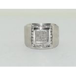 A substantial w/g gents ring with central diamond panel 1.1cts total. Size U