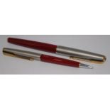 Parker 61 Series 1 fountain pen and LL mechanical pencil in Rage Red with Lustraloy cap. Near