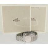 Ladies Hermes watch with supporting paper work on a stainless steel strap