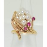 A 14ct yellow gold ring set with cultured pearls and rubies. Size L