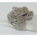 A silver very unusual ring of Cartier Leopard head style set with emerald eyes. Size R