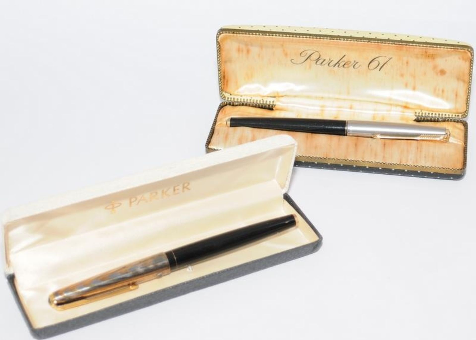 Pair of vintage boxed Parker pens to include a P61 black with rainbow cap and a Parker 61 black De