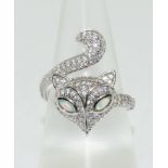 A silver and opal paneled dress ring of cat form. Size R