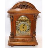 Attractive German mid oak cased chiming bracket clock in good order with pendulum and key, O/all