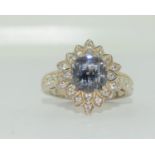 A 925 silver DQCZ flower ring with tanzanite stone to centre. Size O