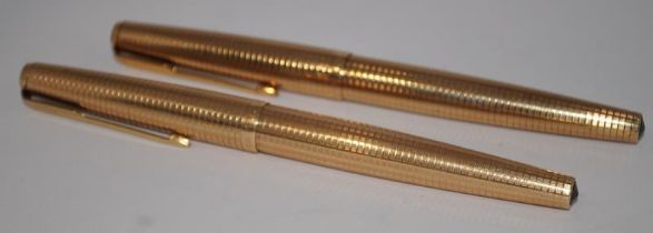 Two Parker 65 Insignia Consort fountain pens in rolled gold. Both in excellent condition. Ref.