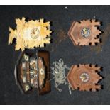 A collection of four vintage wooden Cookoo clocks. All appear to be in complete and cosmetically