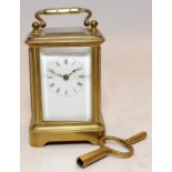 Miniature glass and brass French carriage clock with key standing 7cm tall. Seen working