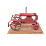 Britool metal model of a tractor on wooden plinth.