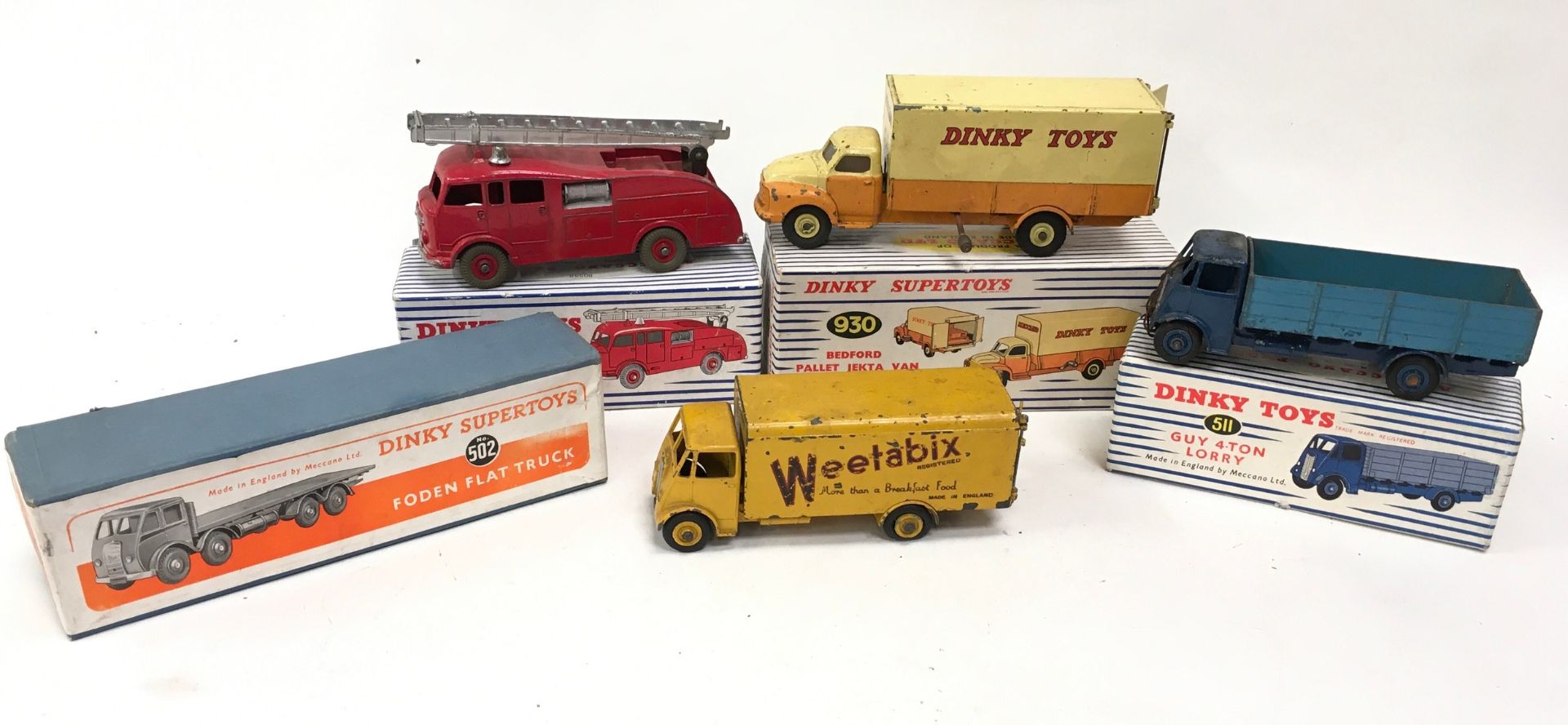 Dinky group to include 555 Fire Engine, 930 Bedford Pallet Jekta Van, 511 Guy 4 ton Lorry - all with