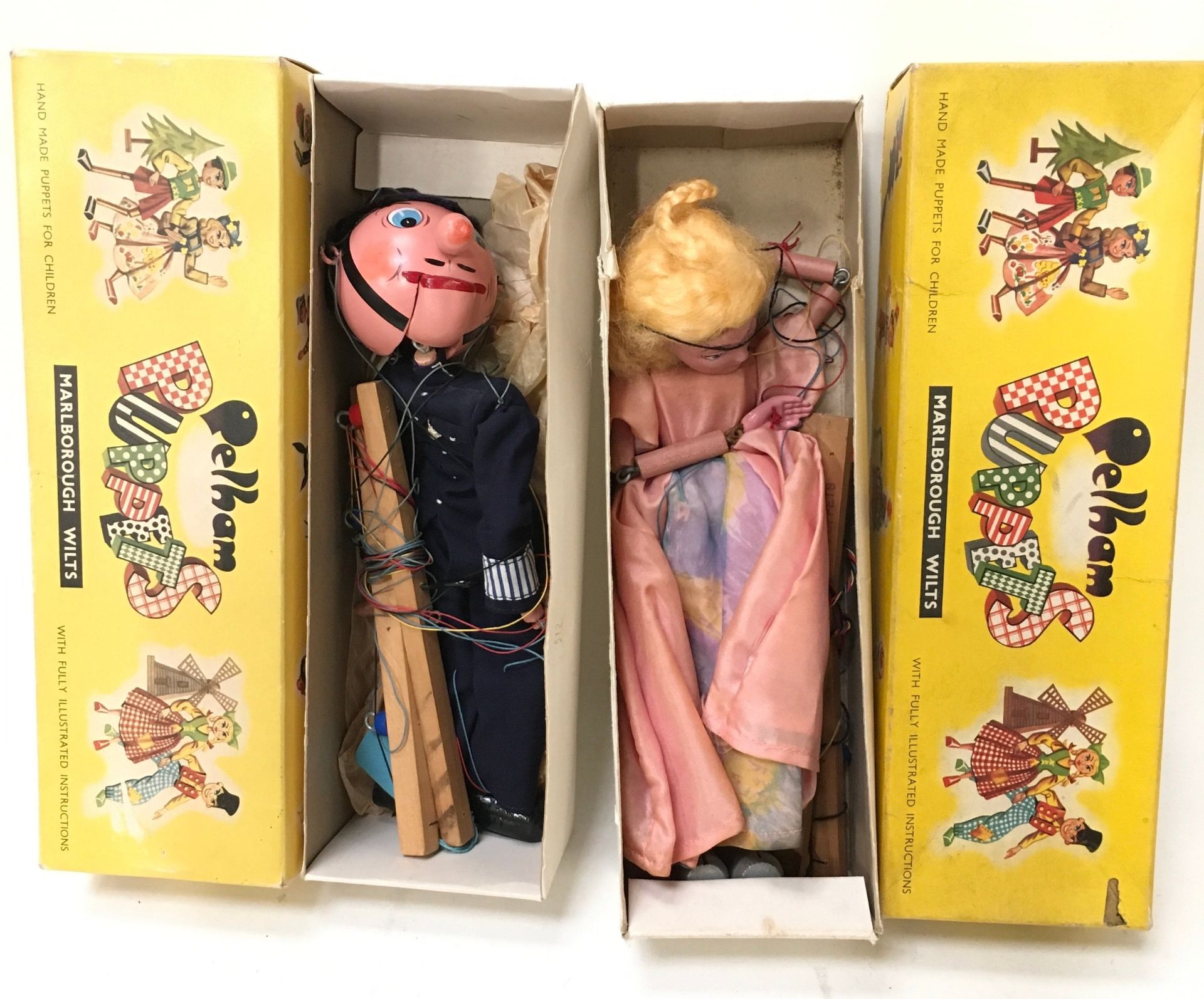 Pair of Pelham Puppets: SM Policeman and SL Cinderella in correct yellow carded boxes.