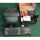 Amstrad console and monitor together with games, instruction manual and a joystick.