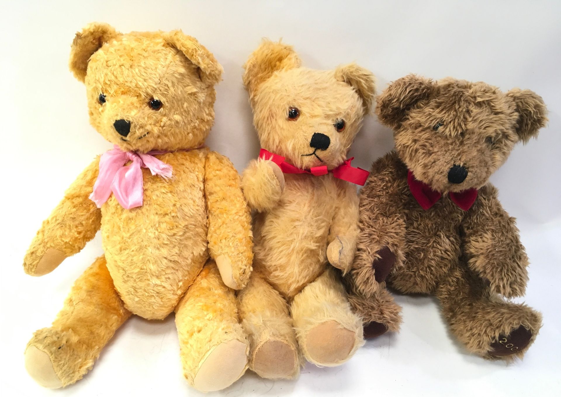 Two vintage teddies and another.