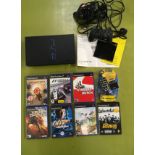 Boxed Sony PlayStation 2 console with two controllers, wireless remote and 7 games.