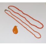 Two coral necklaces with butterscotch amber.