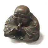 A small aged bronze buddha. (132)