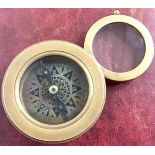 A compass with magnifying glass. (141)
