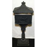 Freestanding reproduction letter post box painted black. Stands approx 120cms tall
