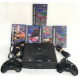 Sega Saturn vintage gaming console with two controllers, power leads and five games.