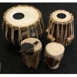 Collection of four drums including ethnic tribal examples