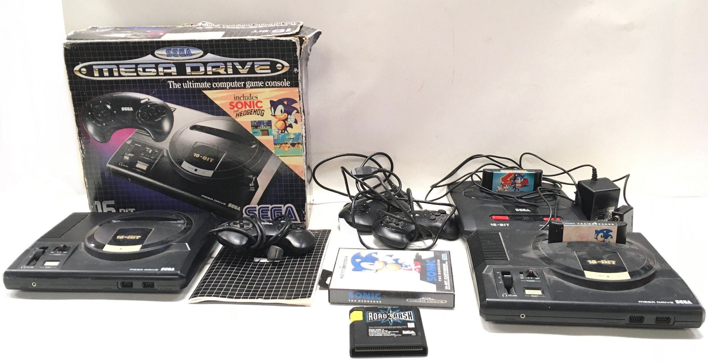 Collection of Sega Mega Drive machines along with controllers and a couple of games.