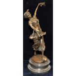 Bronzed dancing figure on a marble stepped base