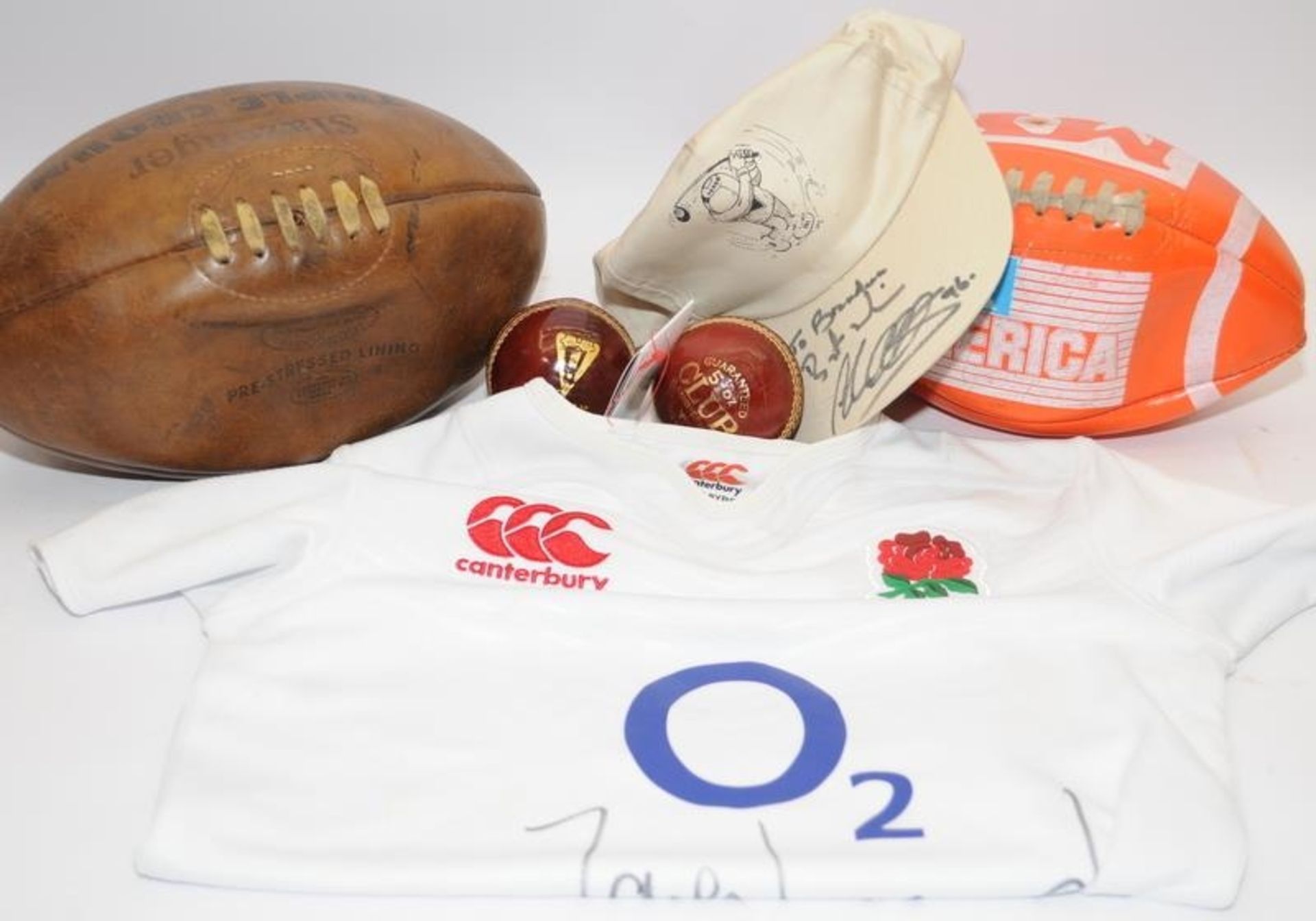 Mixed sports lot to include a vintage lace up Slazenger rugby ball and an England Rugby shirt signed
