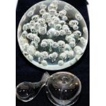 Three clear glass paperweights to include an apple, a whale and a very large sphere with bubbles